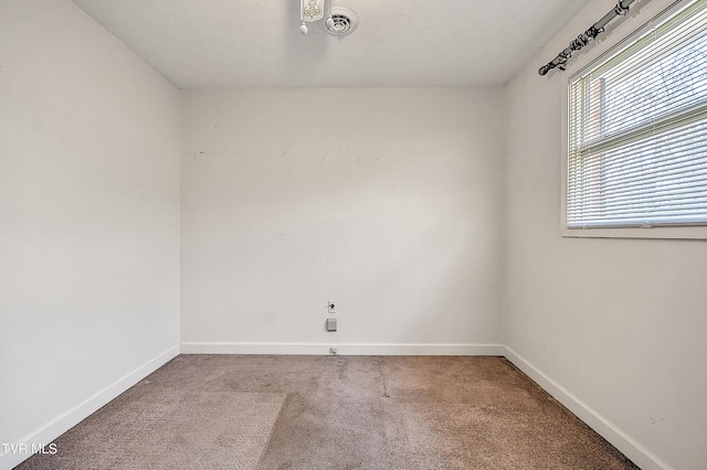 carpeted spare room featuring a textured ceiling