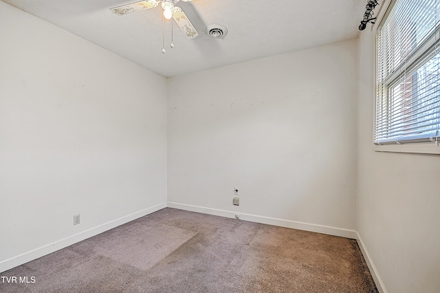 empty room with carpet flooring and ceiling fan