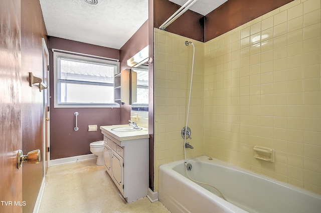 full bathroom featuring vanity, tiled shower / bath combo, a textured ceiling, and toilet