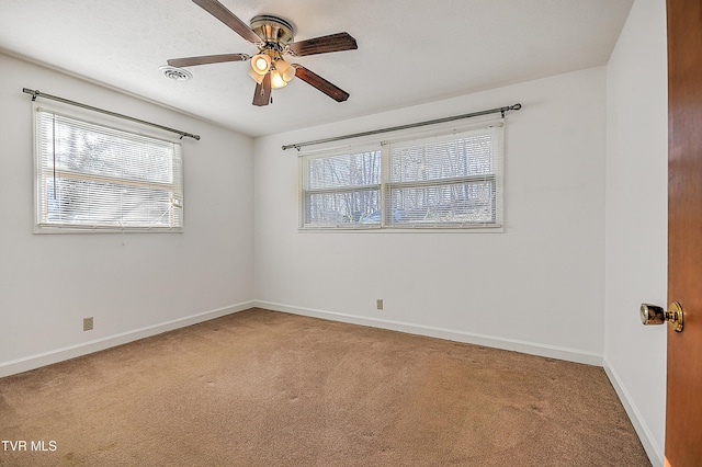 unfurnished room featuring ceiling fan and carpet floors