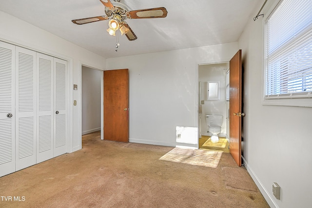 unfurnished bedroom featuring ceiling fan, light colored carpet, and a closet