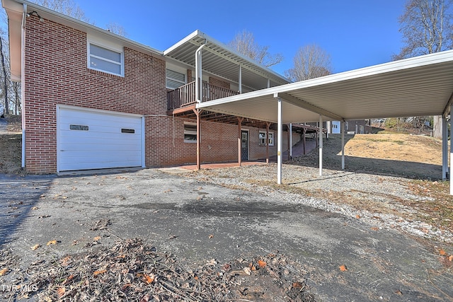 view of side of home featuring a garage and a balcony