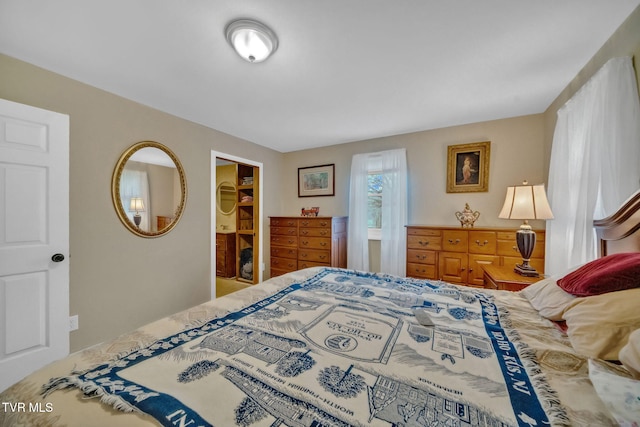 bedroom with a walk in closet and a closet