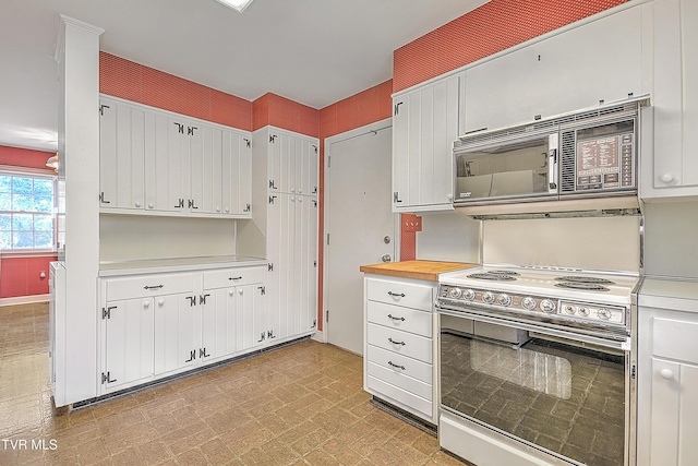 kitchen with white cabinets, black microwave, and electric range