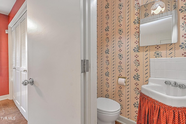 bathroom featuring wood-type flooring and toilet