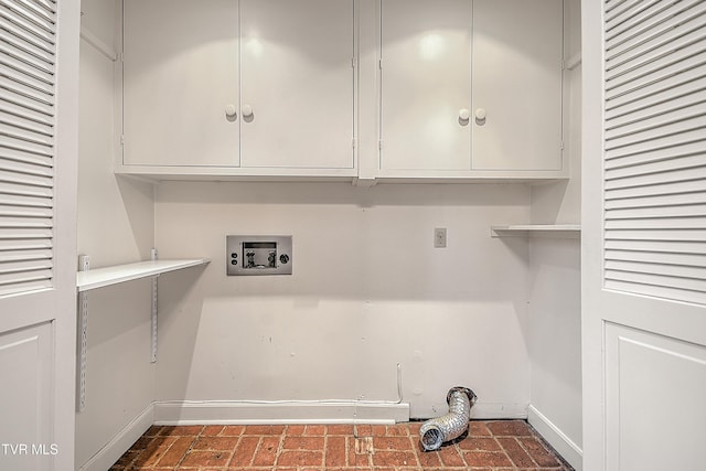 washroom with washer hookup and cabinets