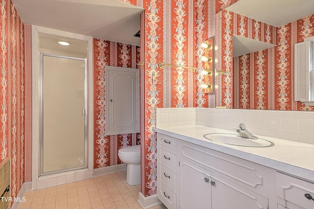 bathroom featuring tile patterned floors, toilet, an enclosed shower, and vanity