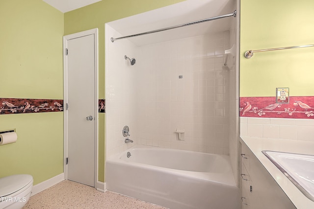 full bathroom featuring tiled shower / bath, vanity, and toilet