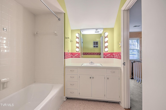 bathroom with vanity and tiled shower / bath