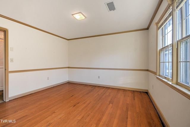 unfurnished room with hardwood / wood-style floors and ornamental molding