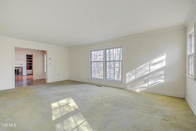 unfurnished room featuring light carpet and ornamental molding