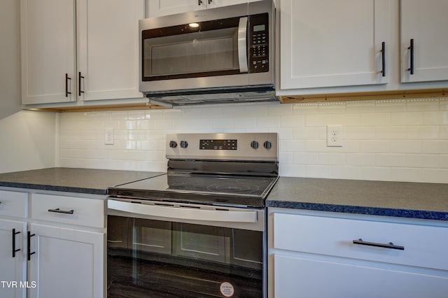 kitchen featuring decorative backsplash, white cabinetry, stainless steel appliances, and wood-type flooring