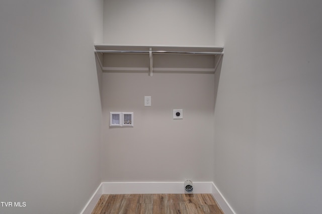 laundry area with electric dryer hookup, hookup for a washing machine, and wood-type flooring