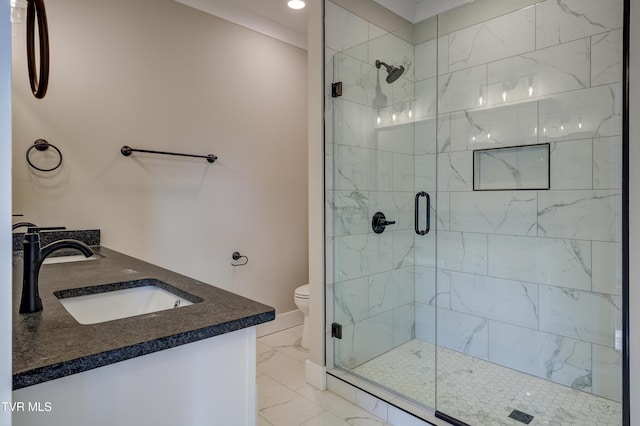 bathroom featuring vanity, a shower with shower door, and toilet