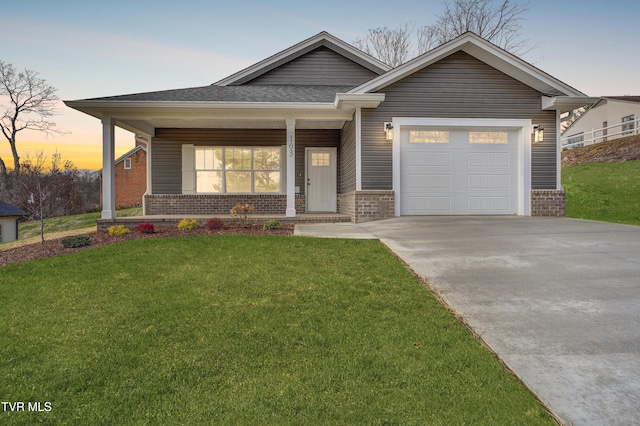 view of front of property with a lawn and a garage