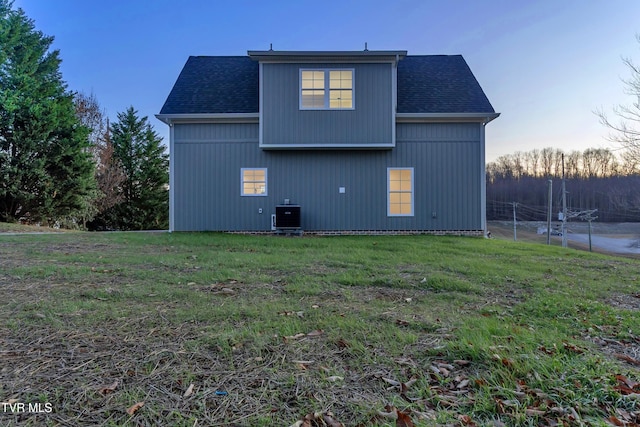 view of property exterior featuring central AC unit and a yard