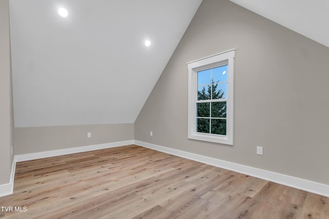 bonus room featuring vaulted ceiling and light hardwood / wood-style flooring