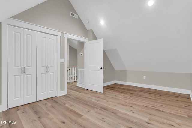 bonus room with light hardwood / wood-style flooring and lofted ceiling