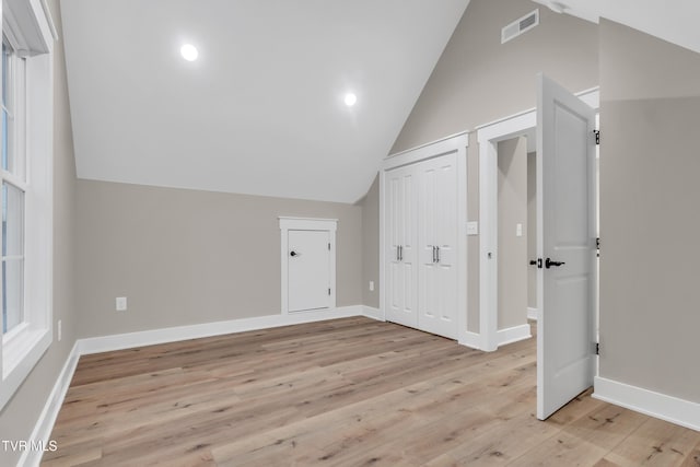 bonus room featuring light hardwood / wood-style flooring and lofted ceiling