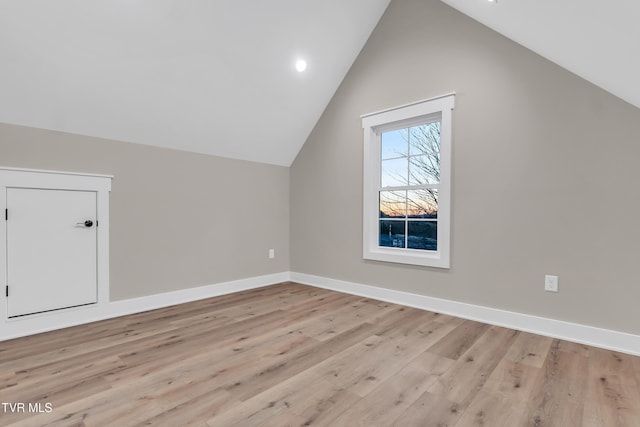 bonus room featuring light hardwood / wood-style floors and vaulted ceiling