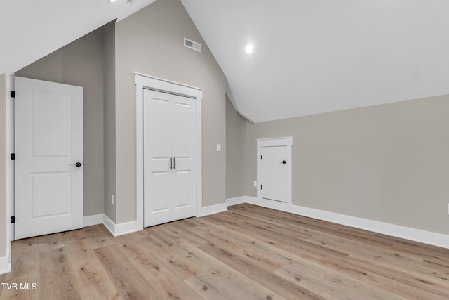 bonus room with high vaulted ceiling and light hardwood / wood-style floors