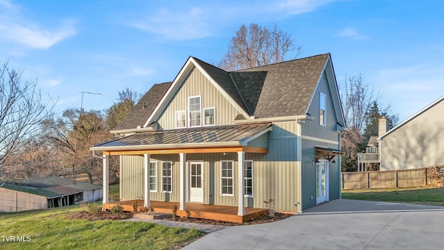 view of front of home with a porch and a front lawn