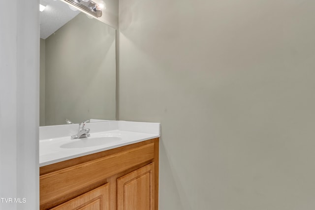 bathroom featuring a textured ceiling and vanity