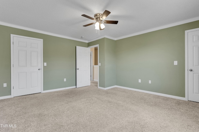 unfurnished bedroom featuring a textured ceiling, carpet floors, ceiling fan, and ornamental molding