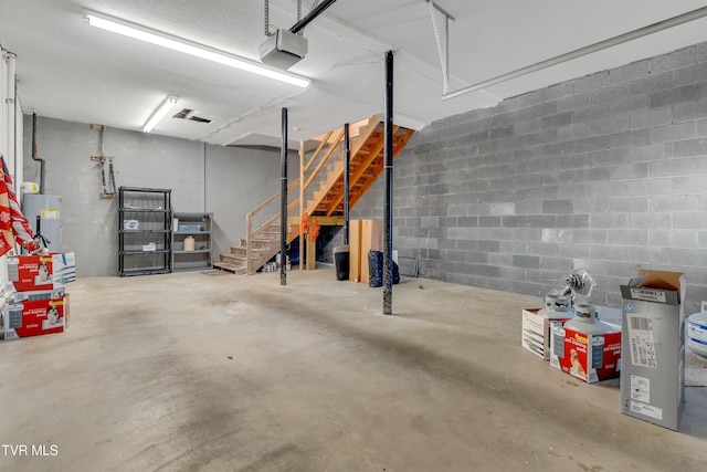 garage featuring electric water heater and a garage door opener