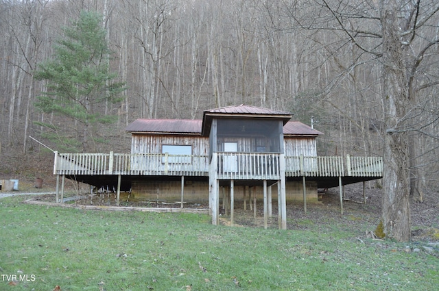 back of property featuring a yard and a wooden deck