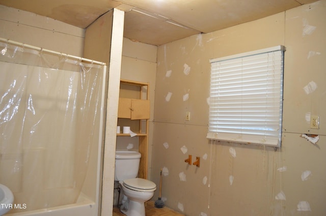 bathroom with shower / bath combo and toilet