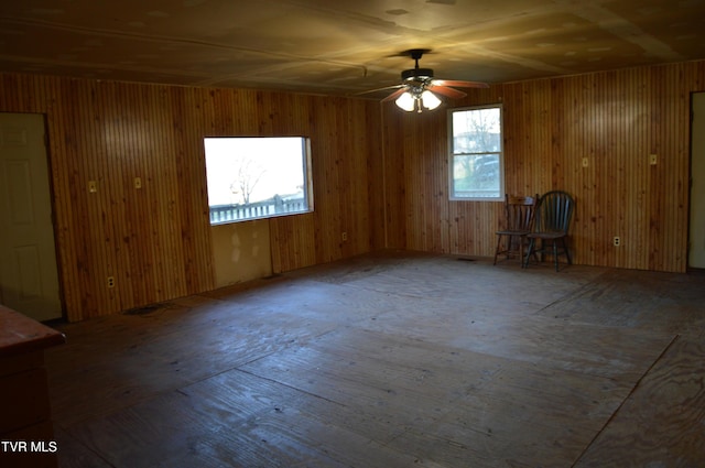 unfurnished room featuring plenty of natural light and ceiling fan