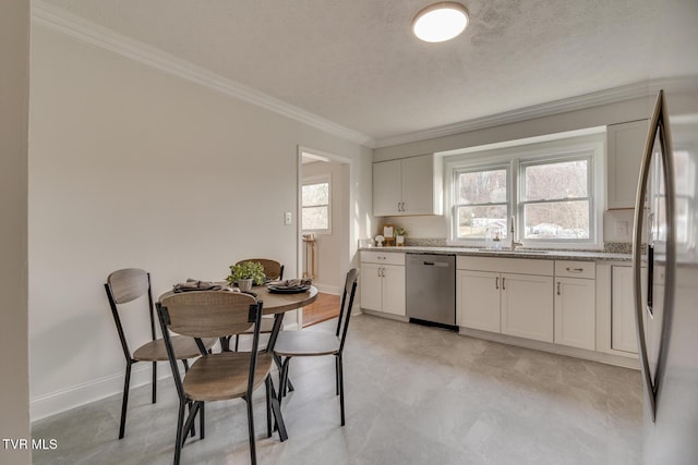 dining space featuring ornamental molding, a textured ceiling, and baseboards