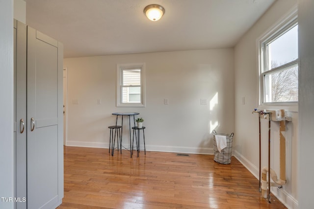 spare room with light wood-type flooring and baseboards