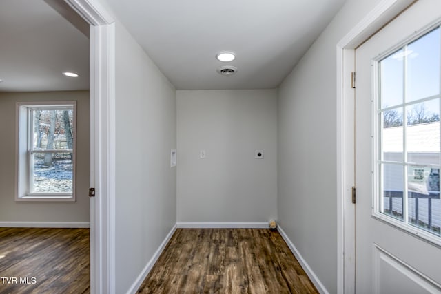 washroom featuring dark hardwood / wood-style floors and hookup for an electric dryer