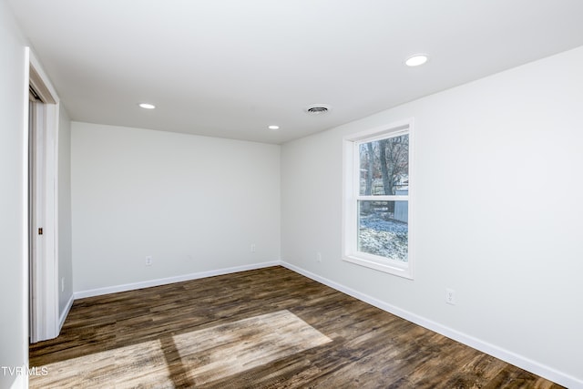 spare room with dark wood-type flooring