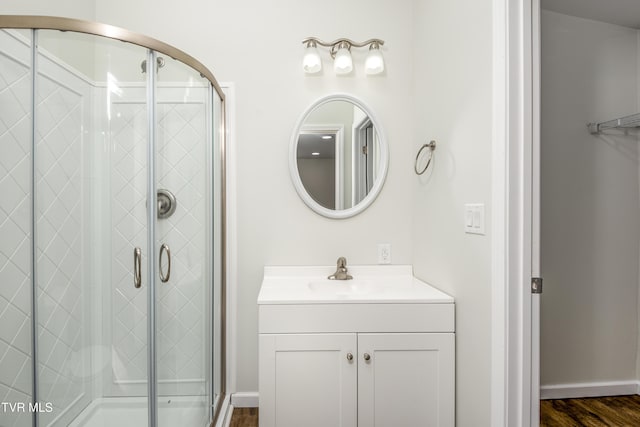 bathroom featuring hardwood / wood-style floors, vanity, and an enclosed shower