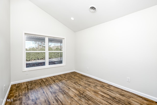 empty room with wood-type flooring and lofted ceiling