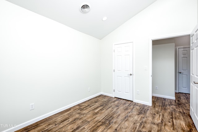 unfurnished bedroom featuring dark hardwood / wood-style floors and high vaulted ceiling