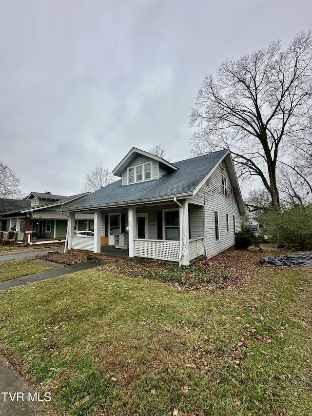 view of front facade with covered porch and a front yard