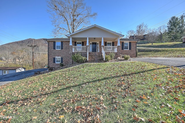 view of front of home featuring covered porch and a front yard