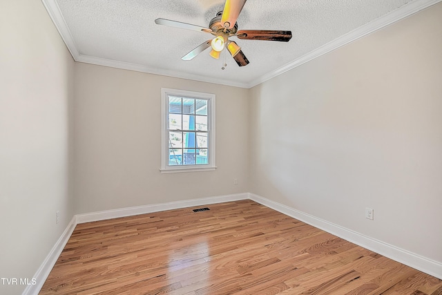 empty room with ceiling fan, crown molding, a textured ceiling, and light hardwood / wood-style flooring