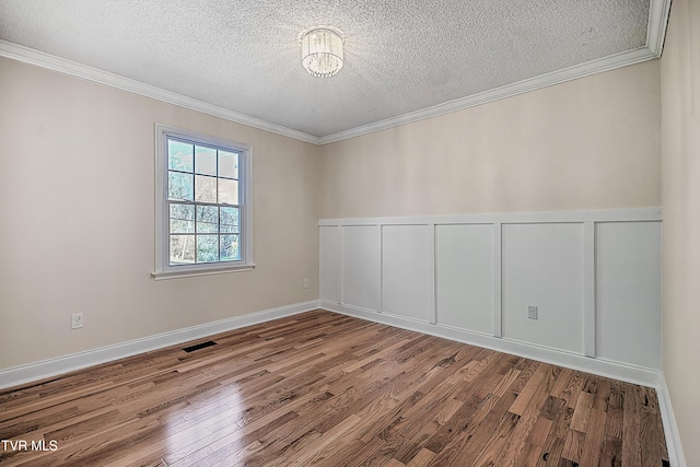 unfurnished room with light hardwood / wood-style floors, a textured ceiling, and ornamental molding