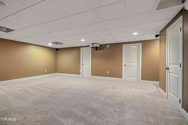 basement with a drop ceiling and carpet