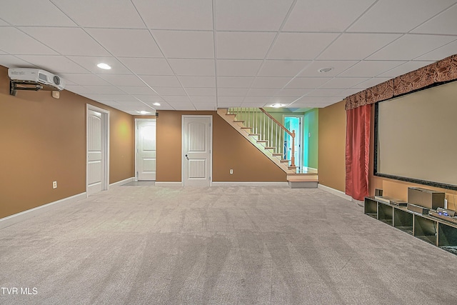 cinema room with carpet flooring and a drop ceiling