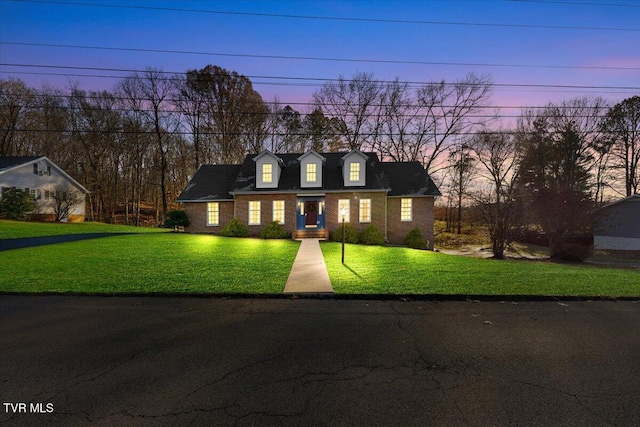 new england style home with a yard