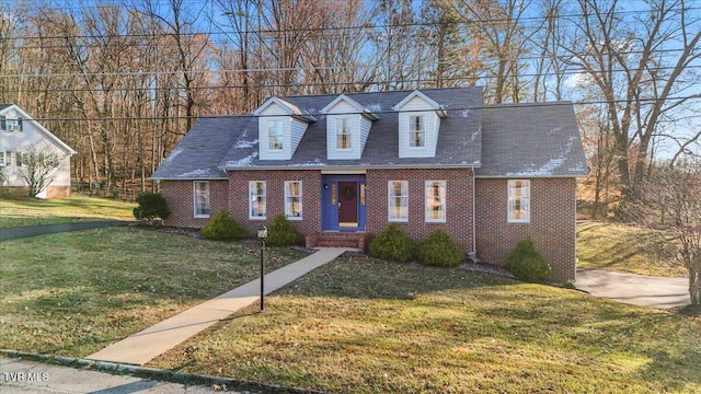 cape cod home with a front lawn