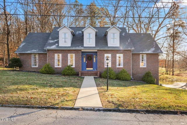 new england style home featuring a front lawn