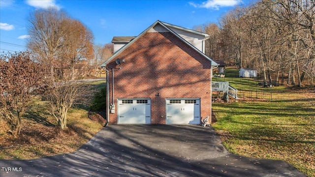 view of home's exterior featuring a garage and a lawn