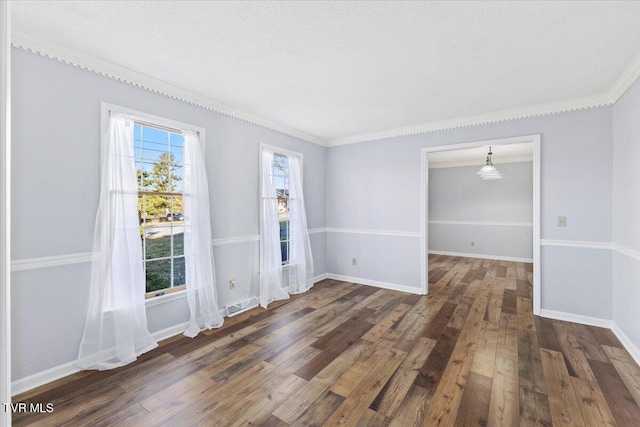 unfurnished room with a textured ceiling, dark hardwood / wood-style floors, and ornamental molding